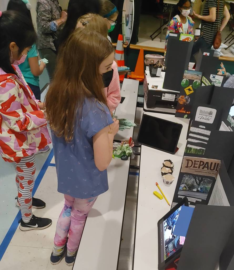 Third-graders check out the variety of causes on display. Andy Nystrom/ staff photo