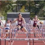Mercer Island High School junior Ari Nguyen, middle, attacks the hurdles during a 3A KingCo race this season. She finished fourth and fifth in the 3A state 100 and 300 hurdles, respectively, in May. Courtesy of Jamie Mitchell