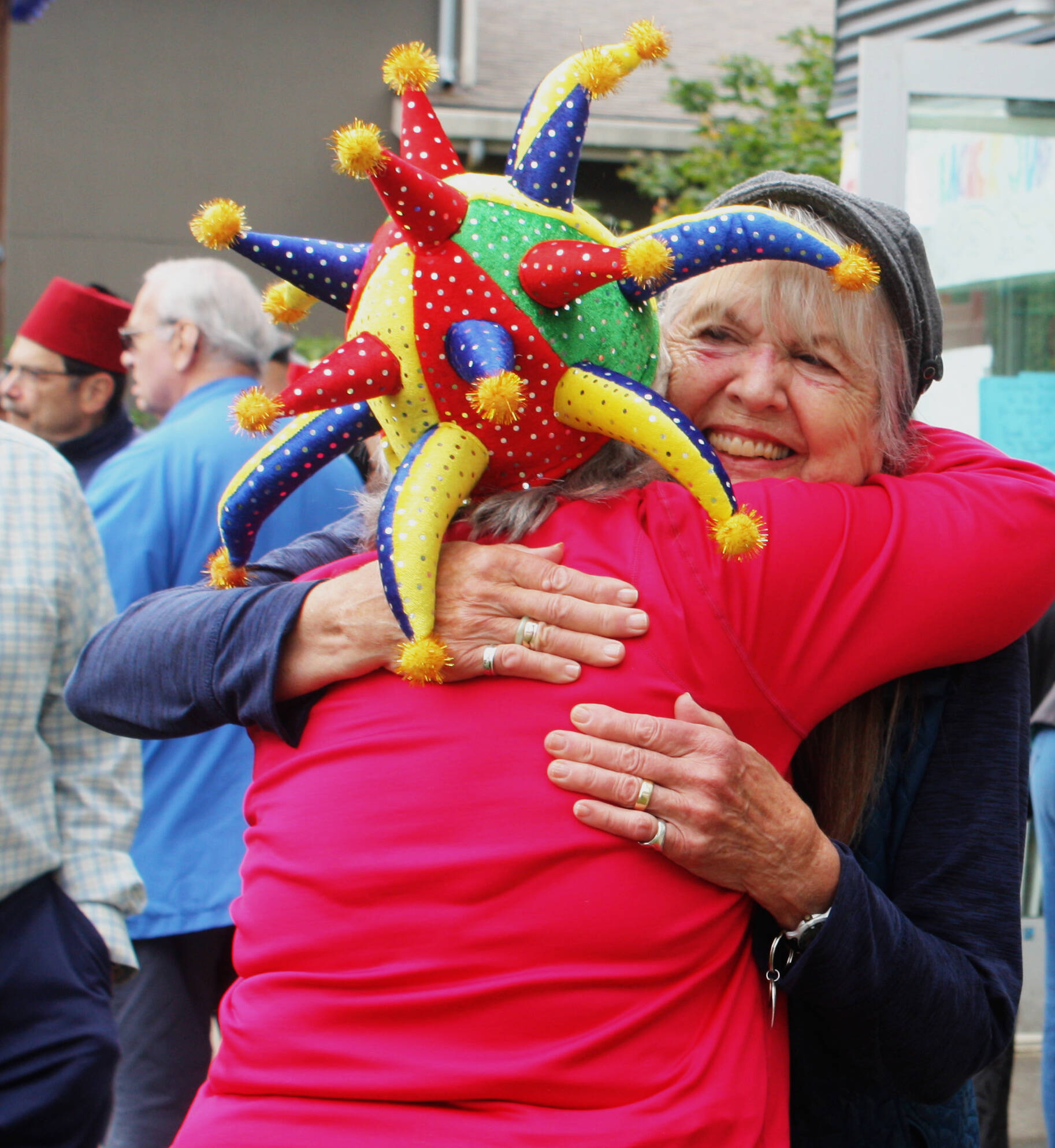 Judy Witmer hugs her friend Sue Yates at a retirement celebration on June 18 at the playground behind the PEAK Mercer Island Boys and Girls Club building. Some attendees wore funny hats and sang for Witmer. Andy Nystrom/ staff photo