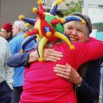 Judy Witmer hugs her friend Sue Yates at a retirement celebration on June 18 at the playground behind the PEAK Mercer Island Boys and Girls Club building. Some attendees wore funny hats and sang for Witmer. Andy Nystrom/ staff photo