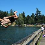 Fedor Osipov, 15, flips into Steel Lake in Federal Way during last year's heatwave on June 28, 2021. Olivia Sullivan/Sound Publishing