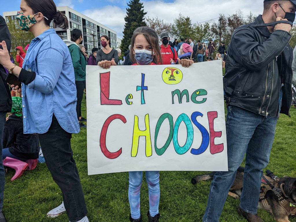 A young girl holds a sign saying Let me choose during a reproductive rights protest at Cal Anderson Park on May 14, 2022. Hannah Saunders/Sound Publishing