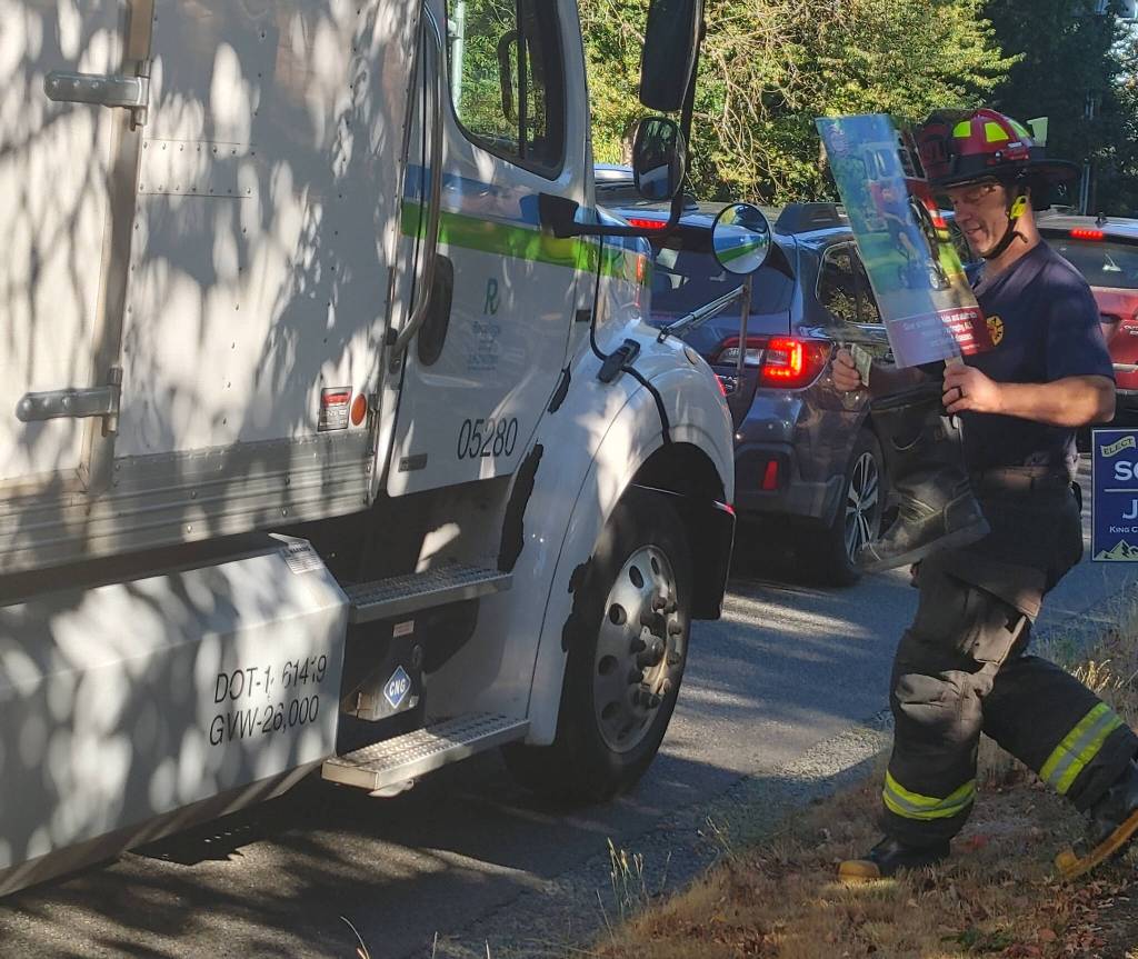 Mercer Island firefighter Ray Austin collects funds for the Muscular Dystrophy Association on Sept. 8 at the corner of Southeast 40th Street and Island Crest Way. Andy Nystrom / staff photo