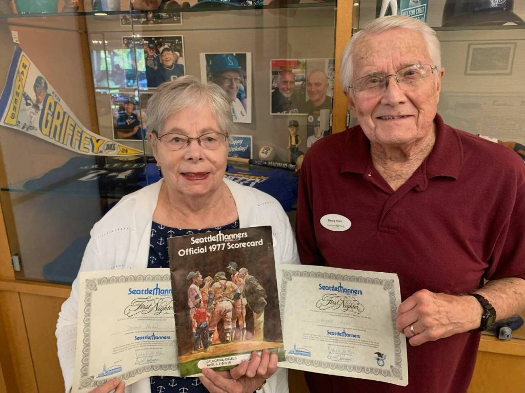 Denny and Sharon Horn, Mercer Island residents, hold certificates and an official program from the Seattle Mariners first home game in 1977, played in the Kingdome. The Horns are among the growing crowd of fan hopefuls cheering the Mariners chances of making postseason play. They watched with pride as Mercer Islander Matt Boyd get his first win as a Mariners pitcher last week. The Horn family and Boyd family are longtime members of Evergreen Covenant Church on the island. Courtesy photo