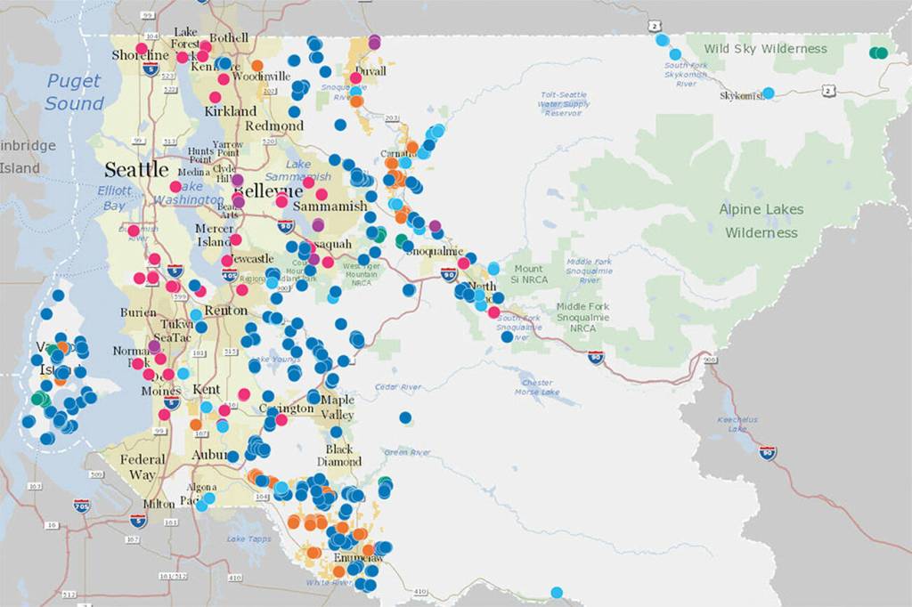 A map of various Land Conservation Initiative projects in King County. Dark blue spots represent natural lands; light blue, rivers; green, forests; pink, urban green space; purple, regional trails; and yellow, farmland. Map courtesy King County