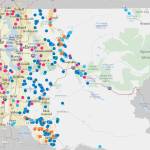 A map of various Land Conservation Initiative projects in King County. Dark blue spots represent natural lands; light blue, rivers; green, forests; pink, urban green space; purple, regional trails; and yellow, farmland. Map courtesy King County