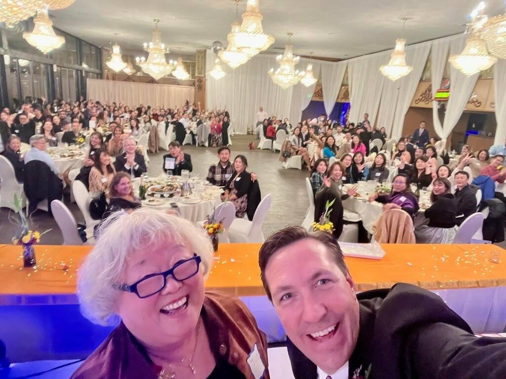 Keynote speakers Fred Rundle and Judy Kusakabe take a selfie with 240 Voices Heard event attendees. Courtesy photo