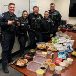 The MI Back the Blue community group provided a Thanksgiving dinner to show its appreciation for the Mercer Island Police Department, featuring, from left, August Owen, Kristina Lum, Sgt. George Schmalhofer, Cpl. Samantha Hammer and Nick Palandri. On behalf of the officers who spent their Thanksgiving holiday at work, I want to express my sincere thanks for your exceptional generosity in providing them with a wonderful Thanksgiving day dinner, said Chief Ed Holmes in a letter to the group. Working in a community that supports their police department means so much to all of us. You all play a significant role in making this a great place to work as a police officer. The group members are: Carv Zwingle, Susan Lund, Gary Robinson, Fay Wang, Laura and Mae Brado, Corinna Sager, Terry Wong and Christina Hogue. Courtesy photo