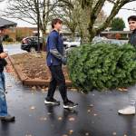 Evan Otte and Sam Dilworth carry a tree to a car at the Mercer Island Community Holiday Tree Lot on Nov. 26. Photo courtesy of Kym Otte