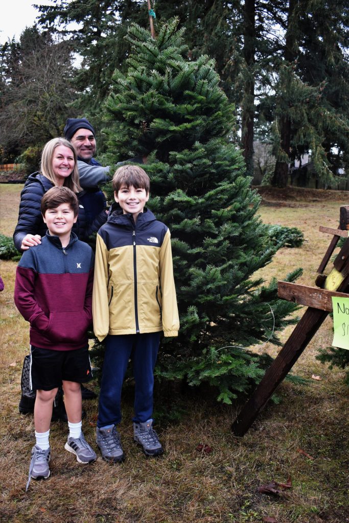 The Apodaca family selects its tree at the Mercer Island Community Holiday Tree Lot on Nov. 26. Photo courtesy of Kym Otte