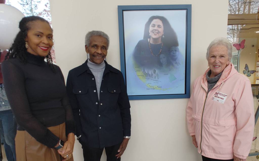 Pictured are Michelle Flowers-Taylor, artist Al Doggett and Maxine Box, Stanley Ann Dunhams classmate at Mercer Island High School. Doggetts portrait of Dr. Dunham prominently hangs on a wall in the school foyer. Andy Nystrom/ staff photo