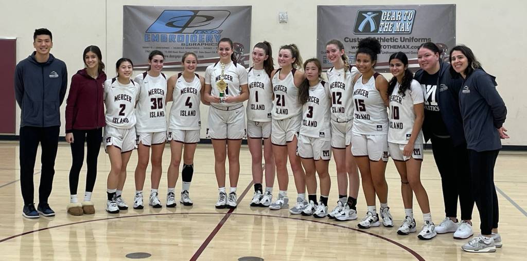 Mercer Island High Schools girls basketball team, from left to right: Coach Tom Choi, Anna Mock, Mylan Bui, Ayden Nov, Kiera Kelly, Kate Nordstrom, Caitlin Monahan, Gabby Lumaco, Anna Marsh, Lauren Monahan, Cassidy Bundy, Aaliyah Khan, coach Lindsey Blaine and coach Katie Warner. Photo courtesy of Carla Monahan