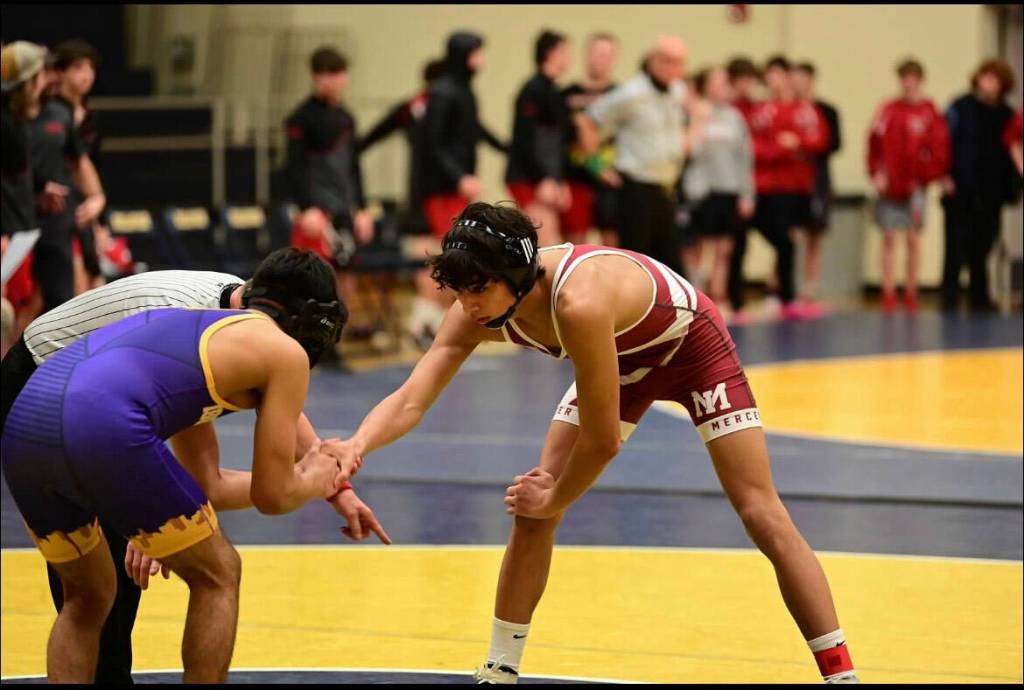 Mercer Island High Schools Chase Warnick, right, prepares to battle an opponent on the wrestling mat this season. Photo courtesy of Aaron Koopman