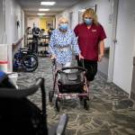 Olivia Vanni / The Herald
CNA Nina Prigodich, goes through restorative exercises with long term care patient Betty Long, 86, at View Ridge Care Center in Everett on Friday.