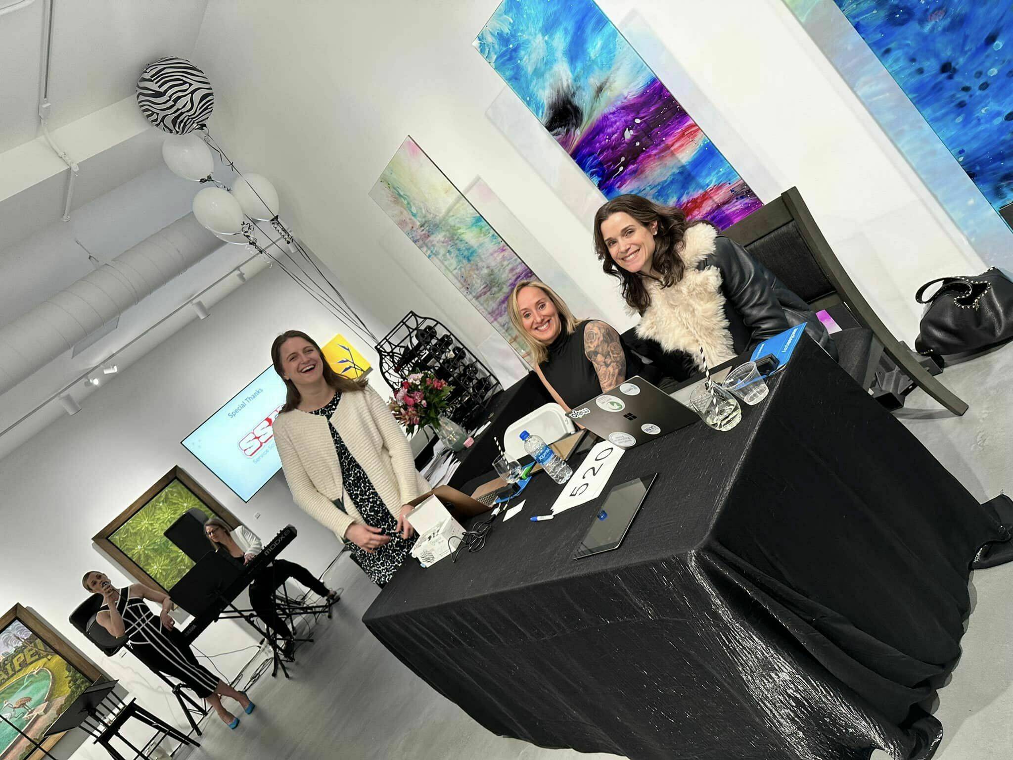 Many Islanders attended the recent Rare Soiree, which was organized by Effie Parks and Jill Hawkins and raised money for rare-disease research. Islander Julie Hsieh donated the art gallery space for the local event, which featured silent and live auctions. More than $60,000 was raised and will be shared between the FAM177A1 Research Fund and CTNNB1 Connect Cure. Volunteers sitting at the table, from right to left: Genevieve Morton, Rachel Harris and Emily Morse. In the background singing, Aly Burks and Deb Brandt, aka The Small Bandits. Photo courtesy of Kristen Elliott