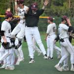 Mercer Island High School (MIHS) player Shane Deguchi and coach Garrett Poore (both center) celebrate the final out in the Islanders 3-0 baseball victory over Lake Washington High School on April 26 at Island Crest Park. Both teams share the 3A KingCo title with 10-2 records and will begin play in the league tournament on May 6 at Bannerwood Park in Bellevue. Earlier in the season, all teams drew straws in case of a tie and LW won the draw and is the No. 1 seed in the tournament and MIHS will get the second seed. At the MIHS Fan Appreciation and Alumni Night on April 26, school Class of 1985 alumnus and former pro pitcher Dave Wainhouse threw out the honorary first pitch. There were at least 300 spectators at the game, an estimated 150 hot dogs and 80 hamburgers sold and many prizes given away such as MIHS Baseball blankets, hats and sweatshirts. Photo courtesy of Kym Otte