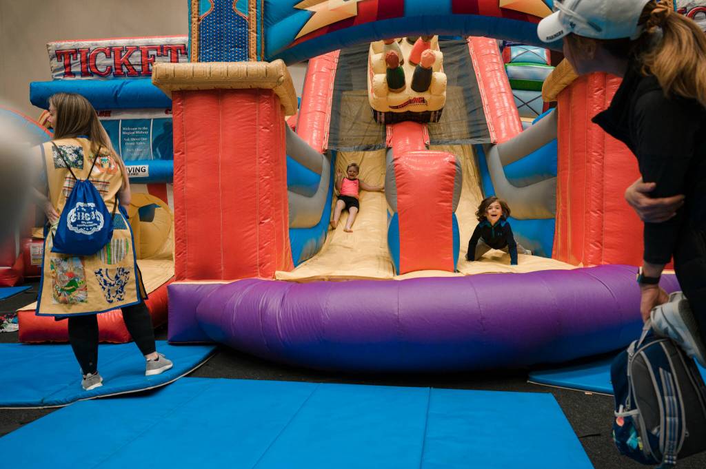 Children slide down the Midway Amusement Obstacle Course at the Mercer Island Preschool Associations Circus on April 29 at Islander Middle School. The 55th annual event featured entertainment (family magician Jeff Evans and The Reptile Lady), activities (Dizzys Tumblebus and Touch a Truck), a petting zoo, food trucks and more. Photo courtesy of Jaimie Birtel Photography