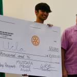 Mercer Island High School senior Mustafa Mehdi Agha received a $10,000 scholarship from the Mercer Island Rotary Club Foundation at its May 2 meeting at the Mercer Island Community and Event Center. Rotarian Wally Boos presented the award to Agha, who has officially committed to attend UCLA in the fall. Andy Nystrom/ staff photo