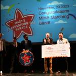 Pictured from left to right on April 1, 2022, at Mercer Island High School, Macys Thanksgiving Day Parade creative producer Wesley Whatley, Mercer Island High School marching band directors Kyle Thompson, Jacob Krieger and Parker Bixby and Macys Bellevue store manager Ryan Ramoso. Andy Nystrom/ staff photo