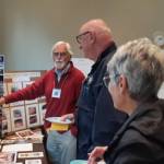 Long-term volunteer Bart Dawson points as he explains an intricacy in one of the organs on which he worked.