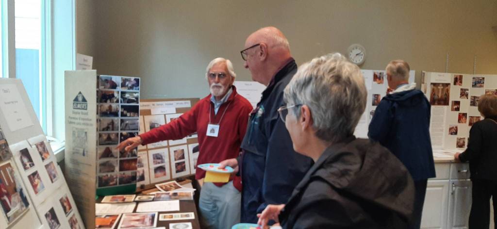 Long-term volunteer Bart Dawson points as he explains an intricacy in one of the organs on which he worked.