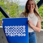 Ashley Dimick holds her winning city of Mercer Island design. Photo courtesy of the city of Mercer Island