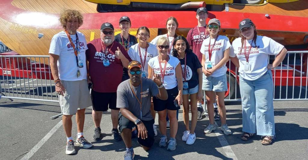 KMIH 889 The Bridge Log Boom Radios three-day broadcast over Seafair Weekend Festival was a resounding success as the student staff tapped into all the live action from the Stan Sayers pits from Aug. 4-6. From left to right: Mercer Island High School (MIHS) video teacher Michael Ketchum, broadcasting teacher Joe Bryant, rising junior Toly Odievich, rising senior Melena Wong, rising senior Sophie Cartwright, broadcasting teacher Natalie Woods, rising sophomore Aadyaa Singhal, rising sophomore Will Prock, rising sophomore Alexandra Foss and rising senior Elise McDonald. Pictured in front is H1 hydro driver and MIHS alum Brent Hall. This year, Seafair had bigger crowds and better quality racing than I have seen in years. Our Log Boom Radio broadcast coverage was also stepped up. Thanks to the great job our students have done in past years, Seafair set us up in a prime spot in the hydro pits with easy access to interview the drivers, pilots, clowns, pirates and everything that makes Seafair great, Bryant said. Photo courtesy of the Mercer Island School District