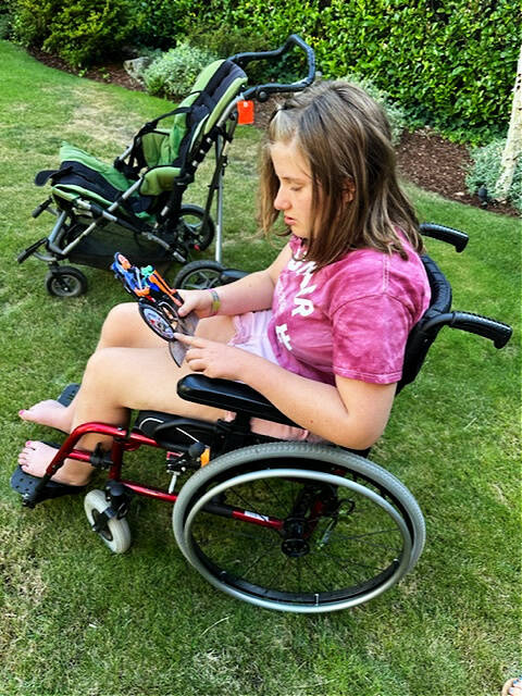 Charlotte Hawkins looks at a photo of Aidan Leung, her beloved Mercer Island High School classmate who passed away last year. Courtesy photo