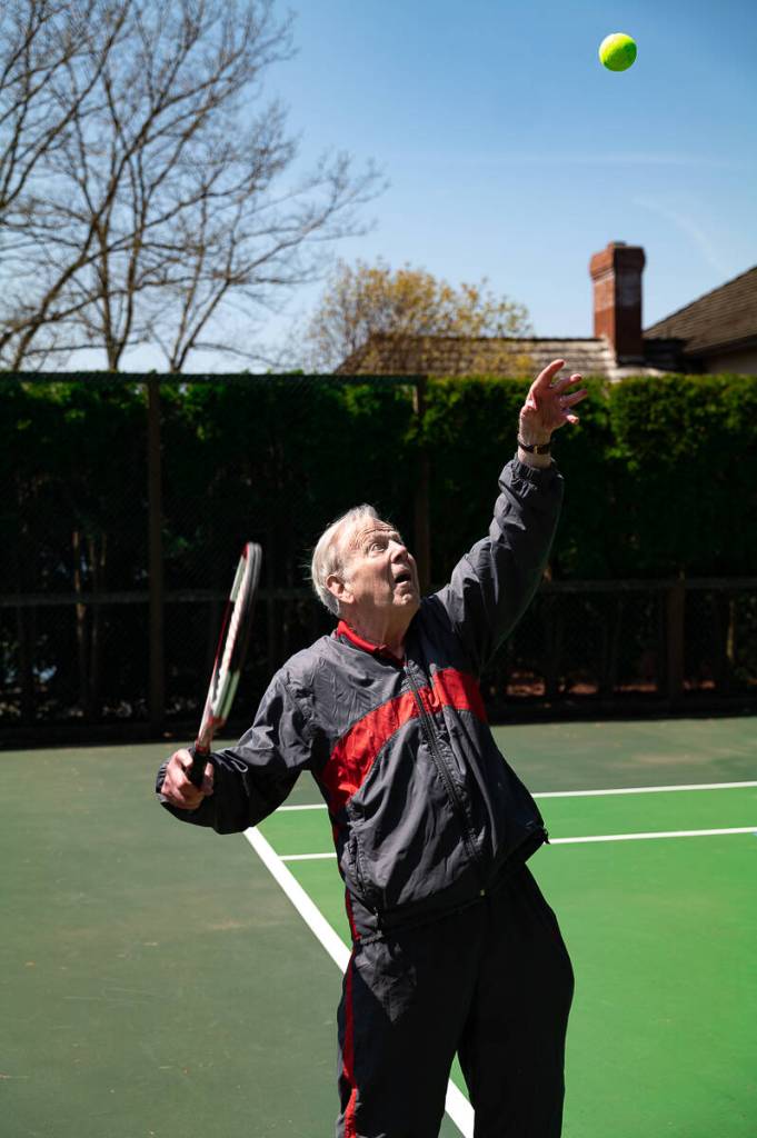 Mercer Islander Charles Chick Hodge unleashes a serve on his home tennis court. Photo courtesy of Michael Perla