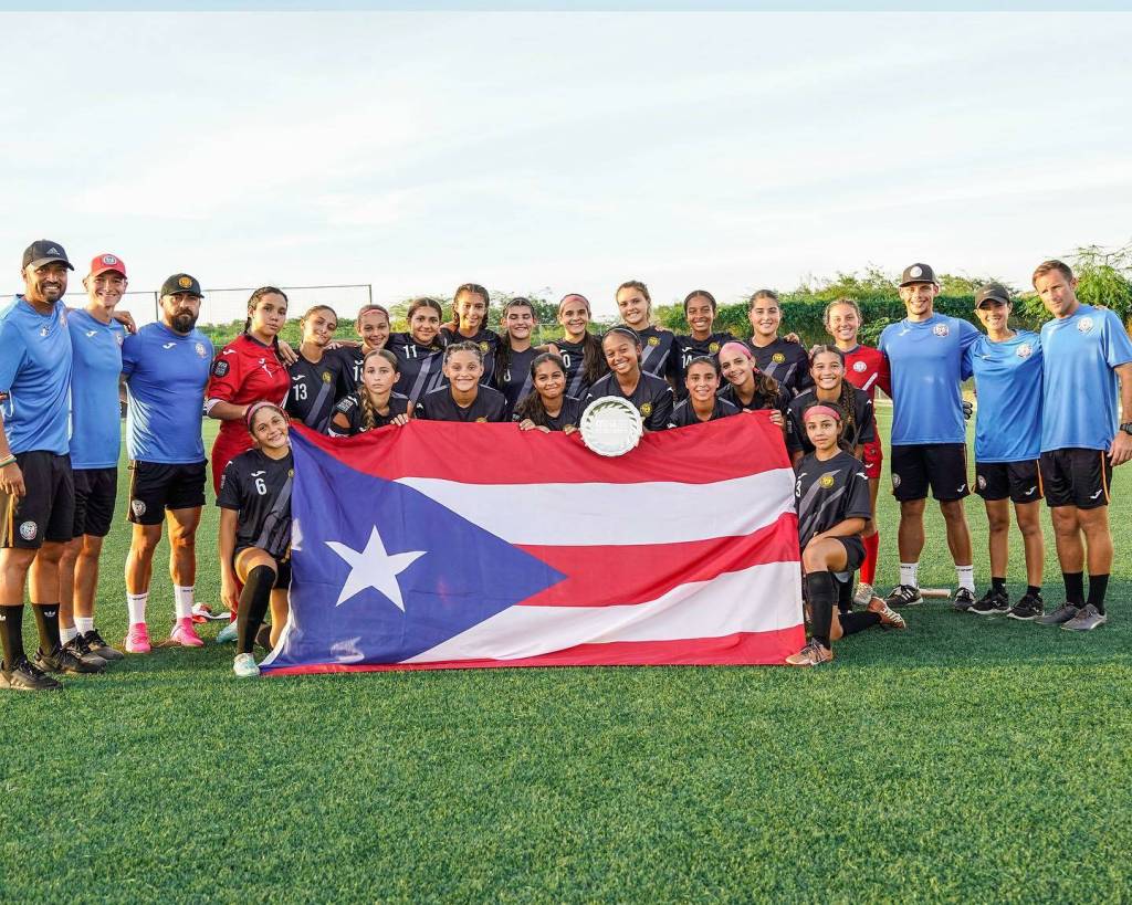 Naomi Johnson, second player from the right in the back row, stands with her Puerto Rican team at the Caribbean Football Union Girls U14 Challenge Series in Antigua in August. Courtesy photo