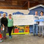 Members of the Mercer Island United Methodist Church raised $9,000 at its Jazz for Tiny Homes student-run concert to help the homeless on Aug. 22 at the church. The check was presented to Sound Foundations NW on Aug. 24. Pictured, in part, are: from second left to right, Becky Dudley, Carol Mariano, Jeff Maners and John Go. About 100 people attended the fundraising event, which featured Mercer Island High School students performing jazz music and an Eastside-based indie rock band unleashing its tunes in the Fellowship Hall. Grace Go and Ryan Hsi were the key event planners. Photo courtesy of Brooks Kahsai