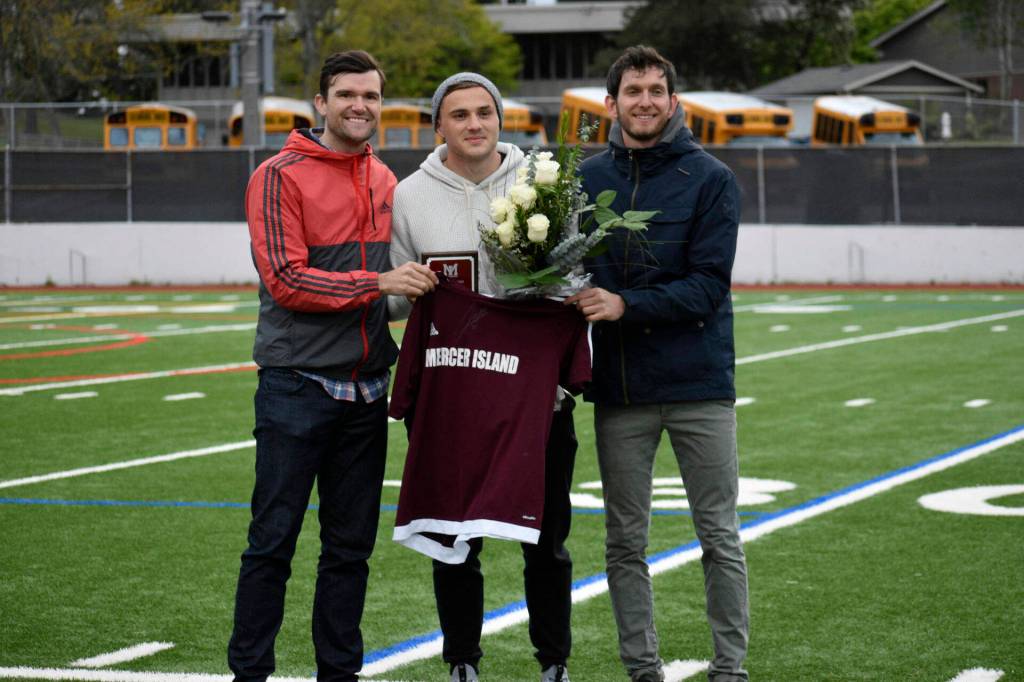 Former Mercer Island Islanders boys soccer head coach Colin Rigby, left, Jordan Morris, center, and former Islanders boys soccer head coach Forrest Marowitz pose for a quick photo on April 23, 2019, at Islander Stadium. Morris was inducted into the Mercer Island High School Athletic Hall of Fame. Photo courtesy of Kim Otte