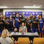 Seven-year-old Ford Parks of Mercer Island poses with the University of Washington mens basketball team while his mother Effie Parks takes photos. Ford, who is battling a rare genetic disorder, signed with the Huskies through Team IMPACT, a nonprofit organization matching disabled children with college athletic teams across the country. Coach Mike Hopkins described the newest addition to the team as tough, hardworking and full of joy, during an emotional ceremony on Oct. 18. Ford will attend team activities, including practices and games, for the next two seasons. He is enrolled at Northwood Elementary School on the Island. Hopkins said: Our program is built around toughness, grittiness and togetherness. Ford is 7, and hes already overcome more adversity than most people do their whole lives. Ford is battling a rare genetic disorder called CTNNB1 Syndrome. Team IMPACT is a Boston-based nonprofit that connects children facing chronic illnesses with college teams. Photo courtesy of UW Athletics