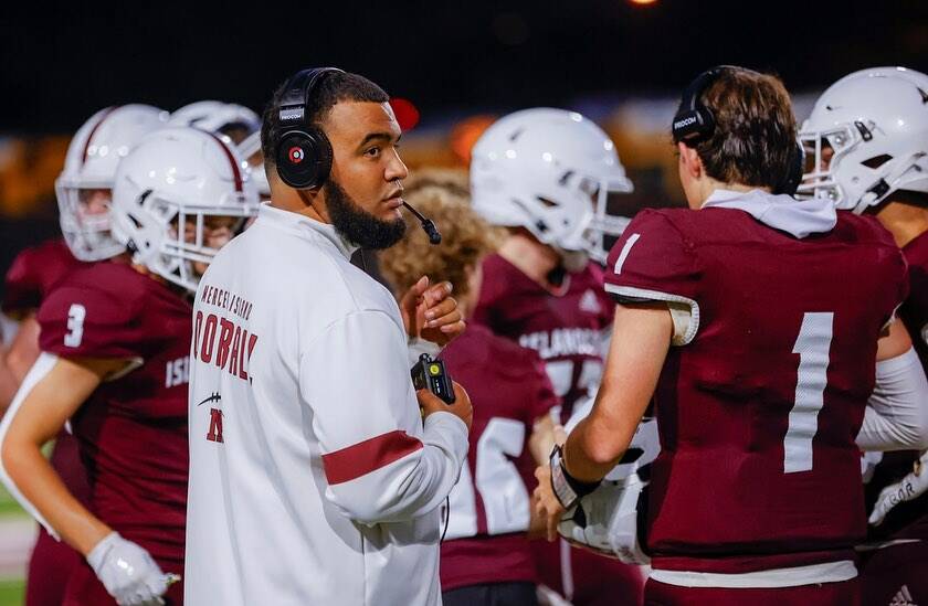 Mercer Island High School football head coach DJ Mims stands amongst his players during a recent game. Photo courtesy of Linda Kercher