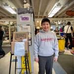 Islander Middle School sixth-grader Bowen Nago stands next to his battery and cellphone collection box inside the Mercer Island Thrift Shop. Photo courtesy of the city of Mercer Island