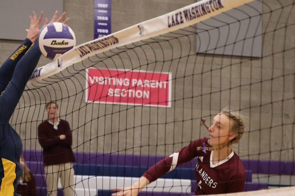 Mercer Island High School junior middle blocker Addison MacKay blasts the ball over the net against Bellevue High School. Photo courtesy of Amy Hopkins