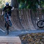 Miles Bailey from the Mercer Island Mountain Bike team gets air while another rider rolls through the new Bike Skills Area, which opened to the public on Nov. 15 at Deanes Childrens Park. Andy Nystrom/ staff photo