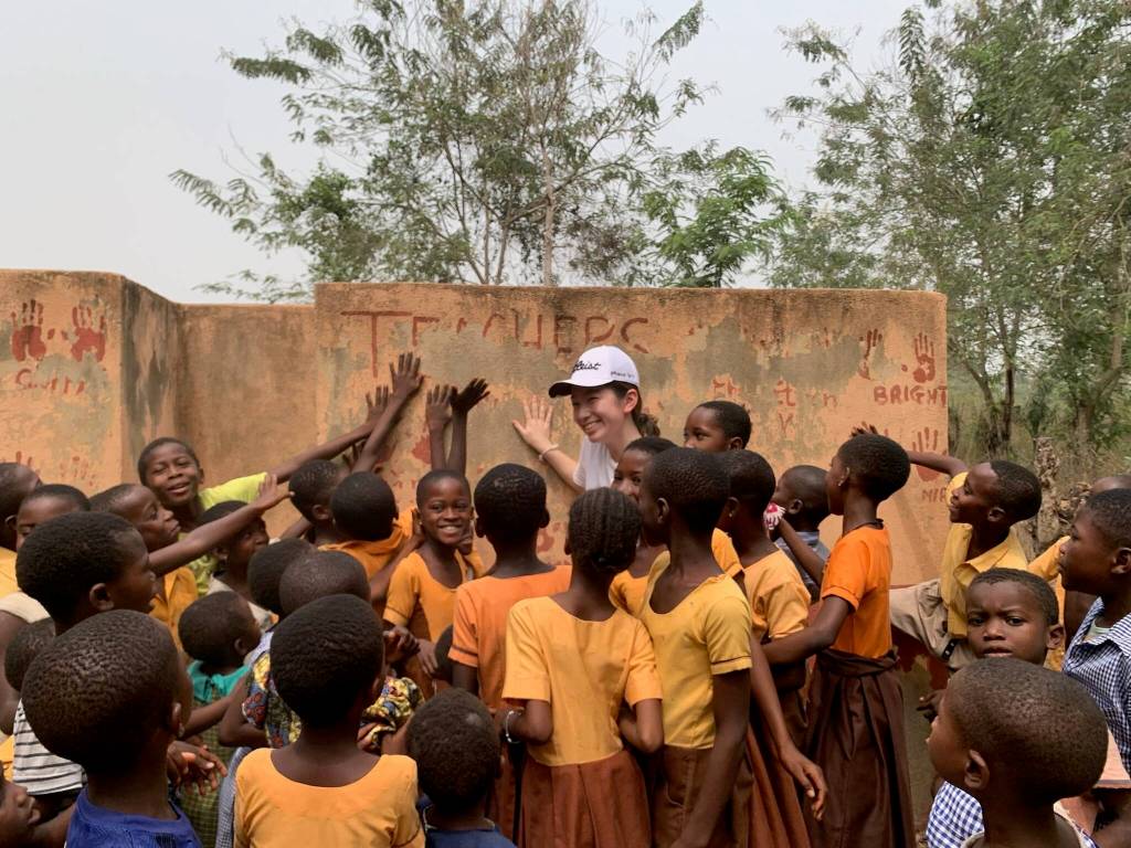 Mercer Islander Chloe Yang touches her hand print as children surround her at a latrine she helped build in Ghanas Mafi Seva village in 2019. This photo was taken in February of 2023. Courtesy photo
