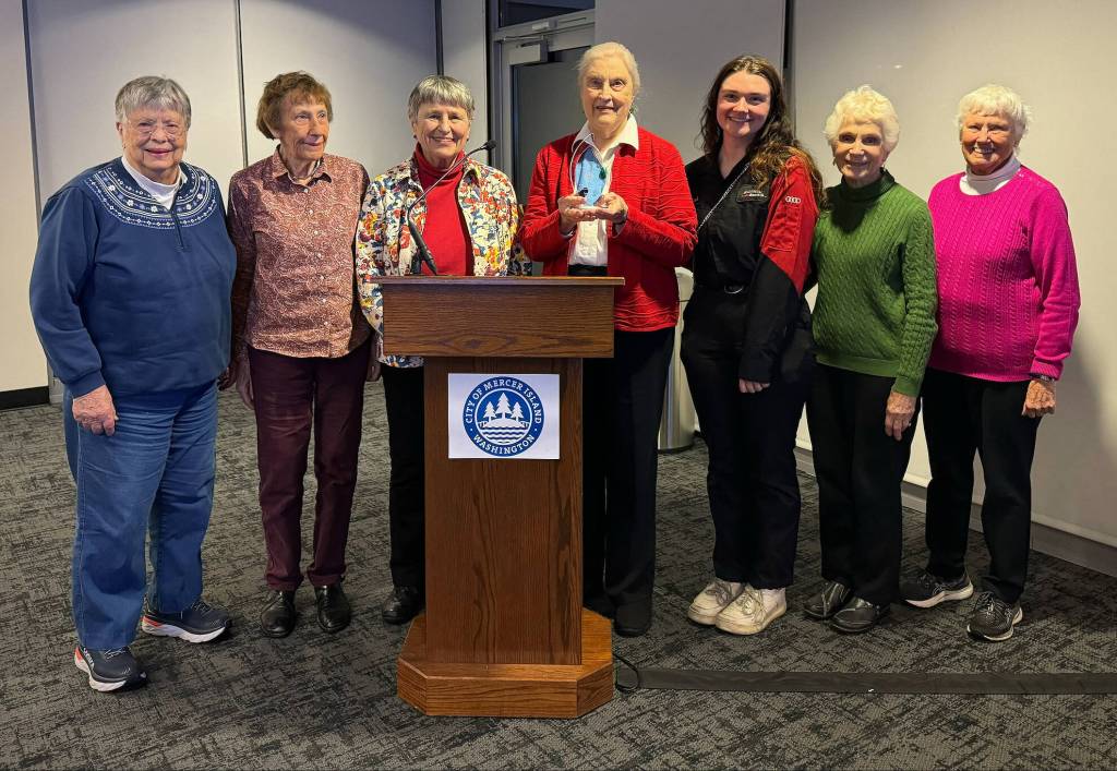 Lola Deane stands with friends at the Dec. 5 city council meeting. Photo courtesy of the city of Mercer Island