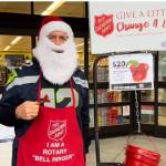 Rotary Club of Mercer Island members collected $1,158.55 from generous Islanders while bellringing for The Salvation Army on a recent Saturday at Walgreens and the north and south QFC markets. Pictured is Pastor Greg Asimakoupoulos, who attracted donors with his singing and his kindness at Walgreens, according to Rotary. Courtesy photo