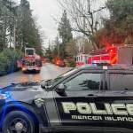 Mercer Island police officers and firefighters with their apparatus cleared the scene of a house blaze off of 84th Avenue Southeast on Jan. 4. No injuries were reported and firefighters had the blaze under control. Eastside Fire & Rescue members and MIs partners at Seattle Fire Department and Bellevue Fire Department teamed up to control the fire, which is under investigation. Photo courtesy of the Mercer Island Police Department