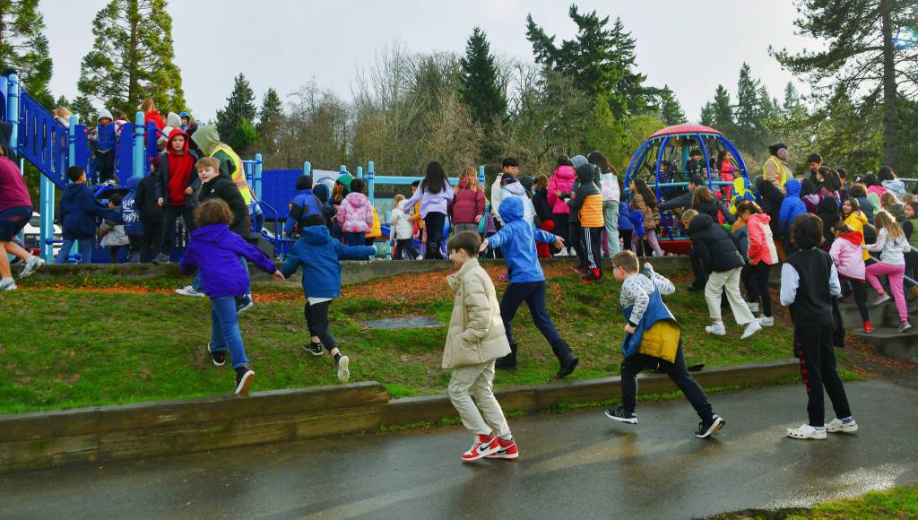 Students invade the new West Mercer Elementary School playground on Jan. 11. Andy Nystrom/ staff photo