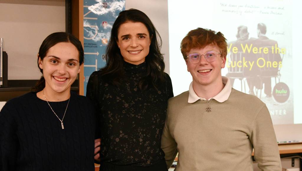 From left, Macy Poll, Georgia Hunter and Daniel Mezistrano following Hunters presentation about her book We Were the Lucky Ones on Jan. 9 at the Islander Middle School Library. Andy Nystrom/ staff photo