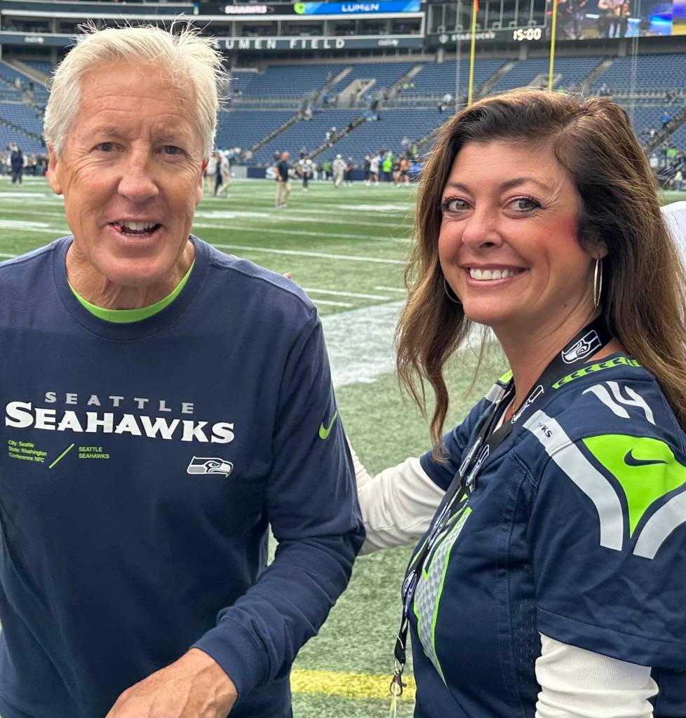 Gregs daughter Kristin was photographed with Pete Carroll on her 40th birthday a recent home game. (Courtesy photo)