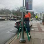 A city worker places parking signage in Town Center. Photo courtesy of the city of Mercer Island