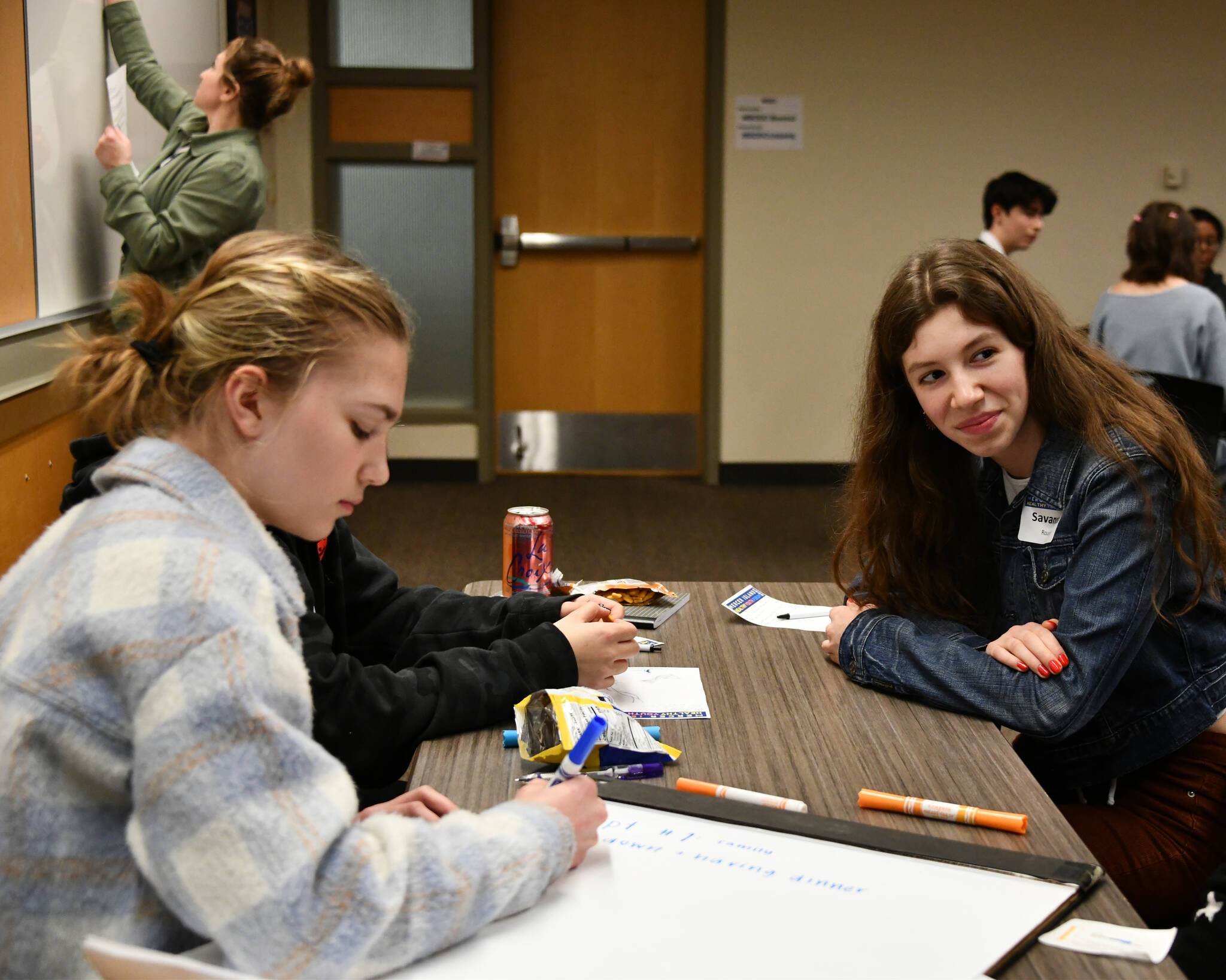 Mercer Island High Schools Savanna Rousell, right, listens to a fellow student while Ina Shapiro, left, takes notes during a breakout session at the MI Healthy Youth Forum on Jan. 31 at the Mercer Island Community and Event Center. Andy Nystrom/ staff photo
