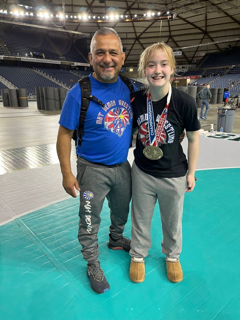 Mercer Islands Emerson Woods with coach Jess Torres at the Washington State Wrestling Folkstyle Championships on Feb. 18 at the Tacoma Dome. Woods notched the 121-pound middle school girls title. Courtesy photo
