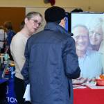 An attendee gains information at the ElderMove Alliance booth. Andy Nystrom/ staff photo
