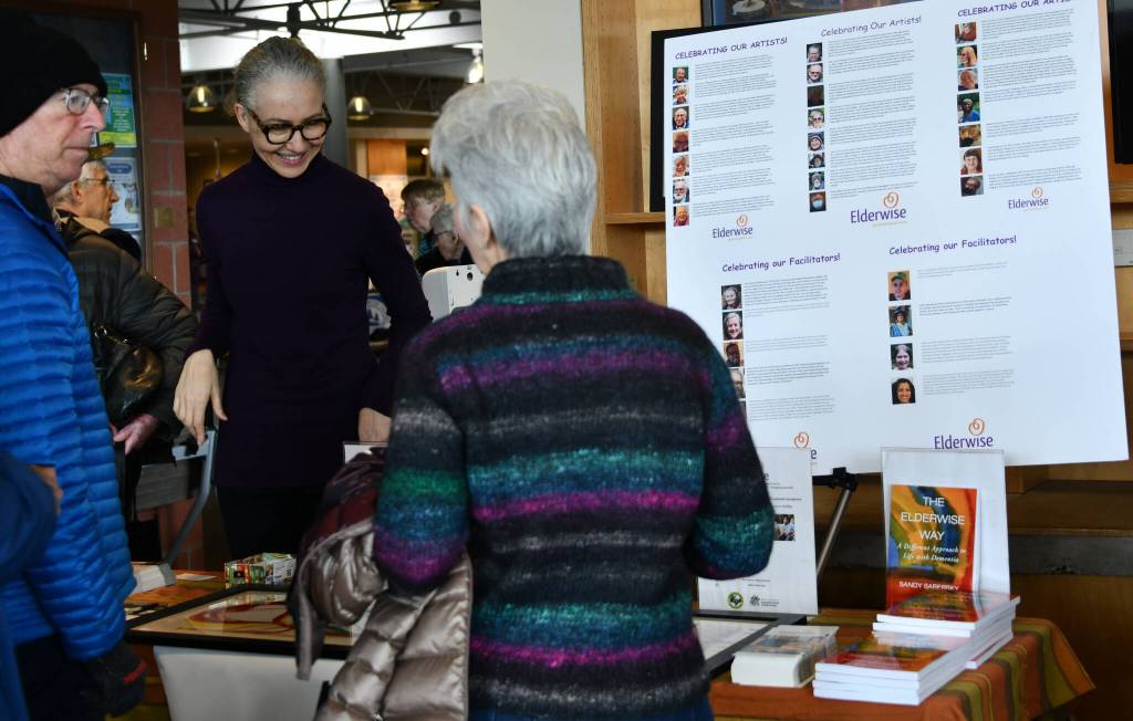 Attendees interact at the Elderwise booth. Andy Nystrom/ staff photo