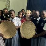 MaryMargaret Welch, PETRI adviser, receives handmade baskets made by Mwakiwiwi Secondary School students. Photo courtesy of Kimberly Miyazawa Frank